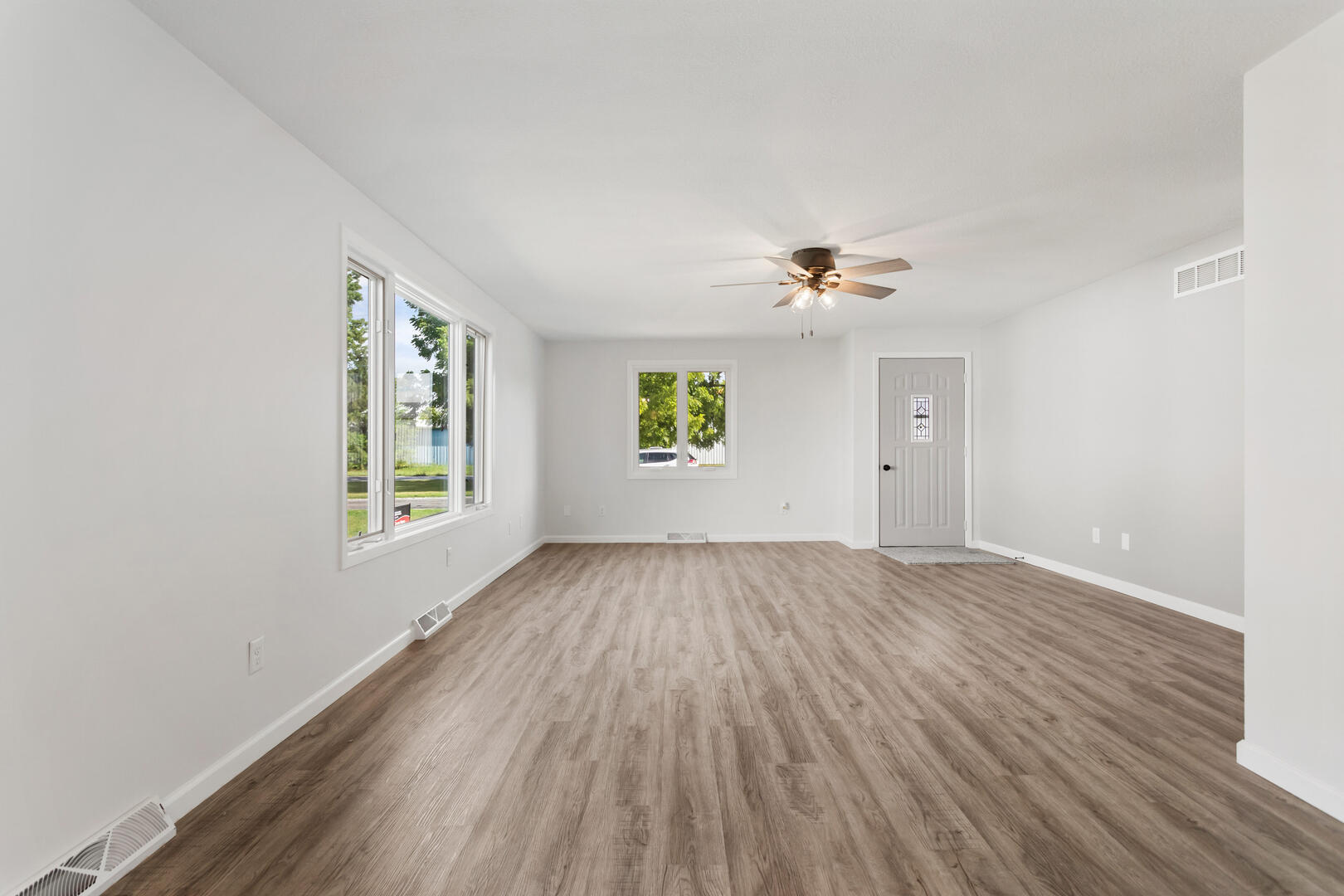 208 Maple Street Ogden, IL 61859 - Photo 5 of 30 an empty room with a window and a ceiling fan