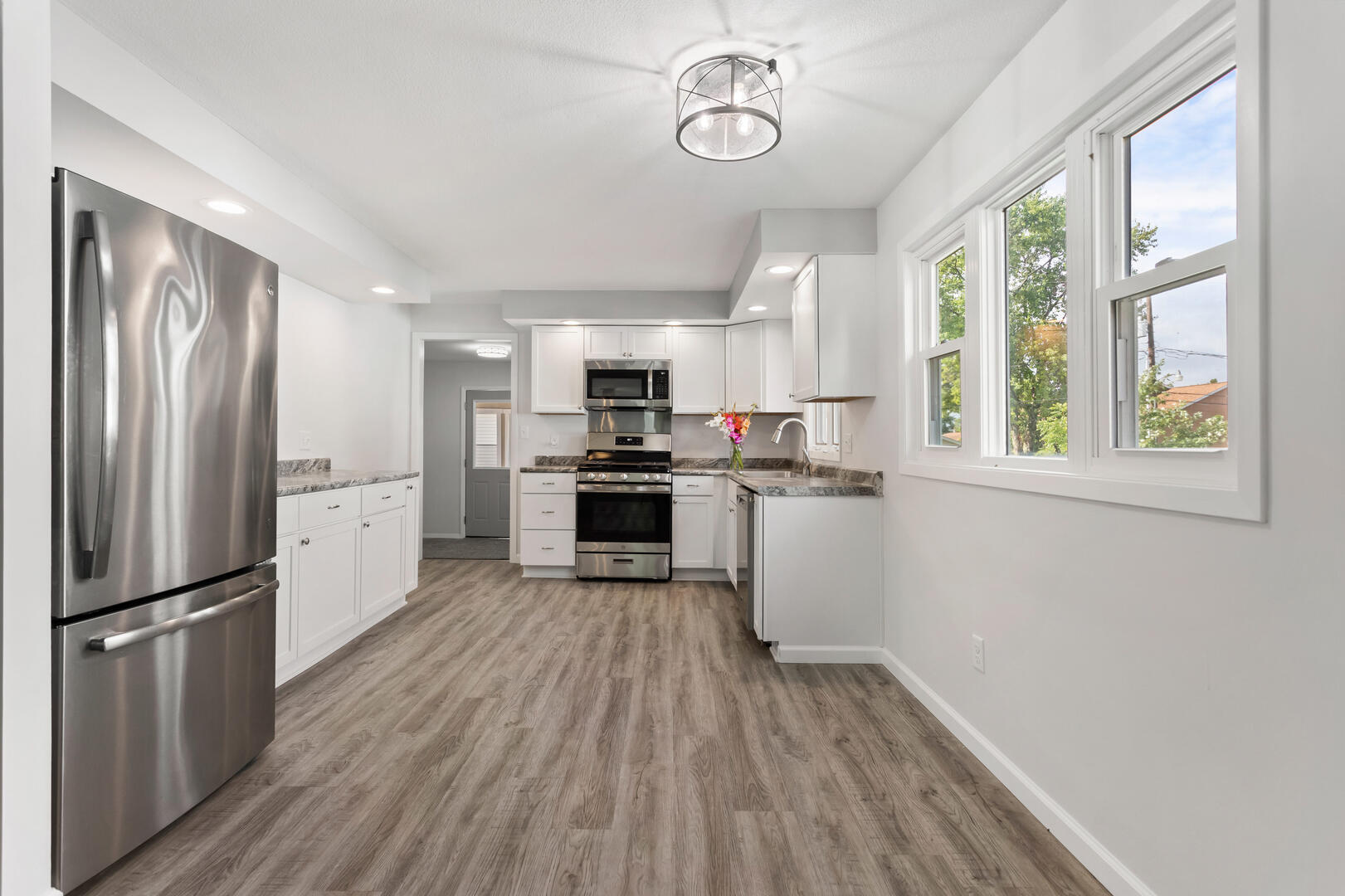 208 Maple Street Ogden, IL 61859 - Photo 7 of 30 a kitchen with stainless steel appliances a refrigerator and wooden floor