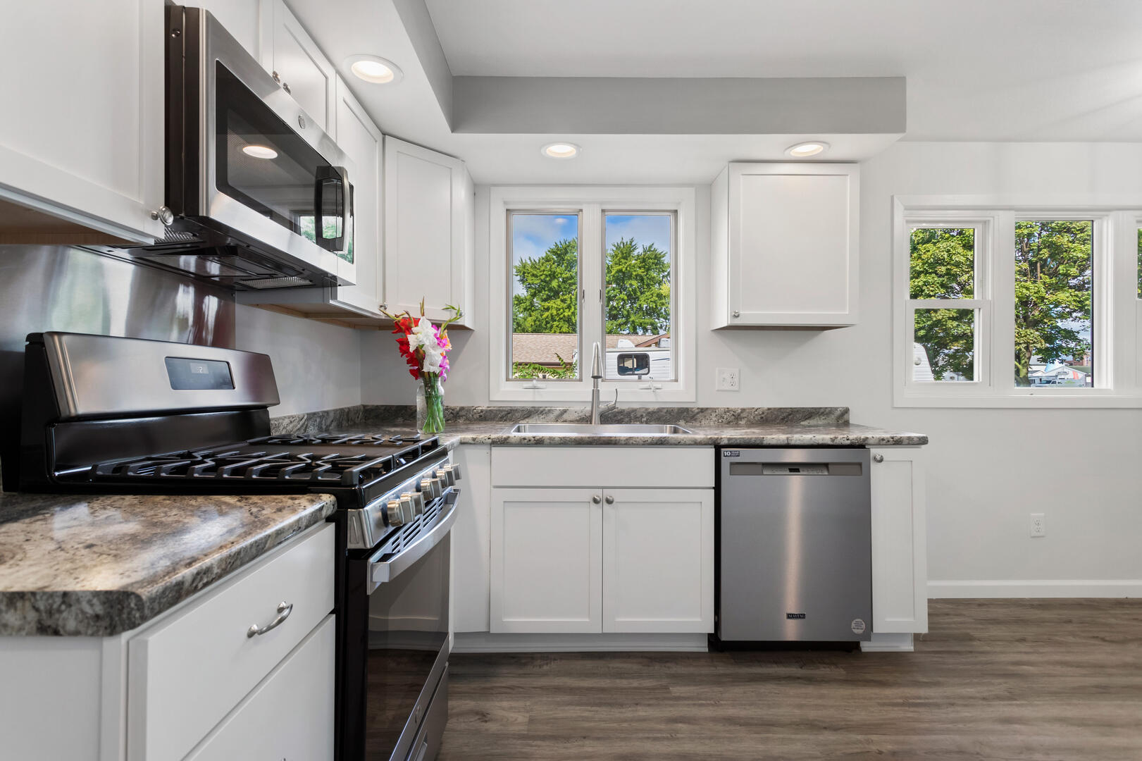 208 Maple Street Ogden, IL 61859 - Photo 8 of 30 a kitchen with stainless steel appliances granite countertop a stove and a sink
