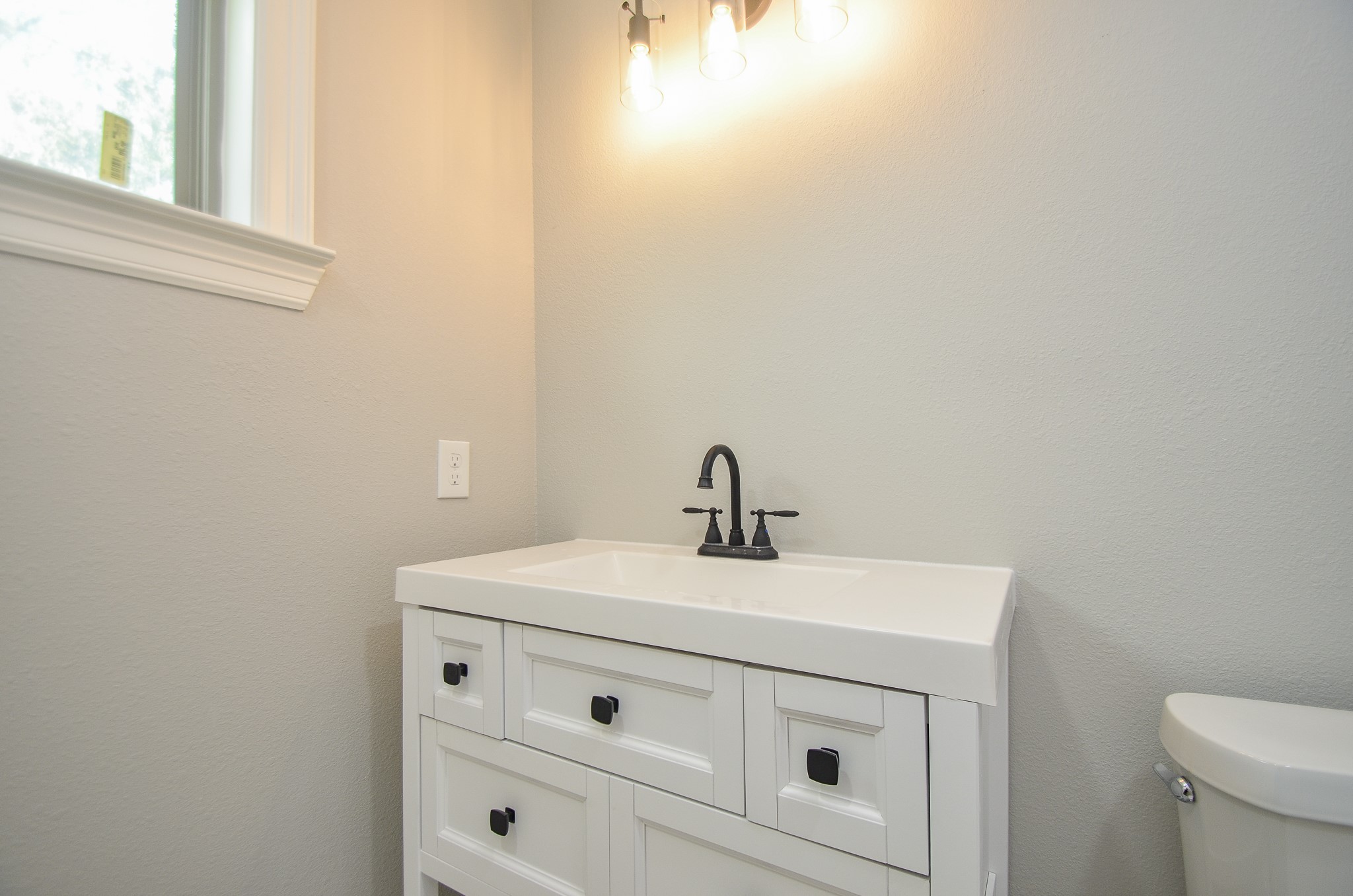 6114 Wedgefield Street Houston, TX 77028 - Photo 11 of 32 a bathroom with a sink a toilet and a window