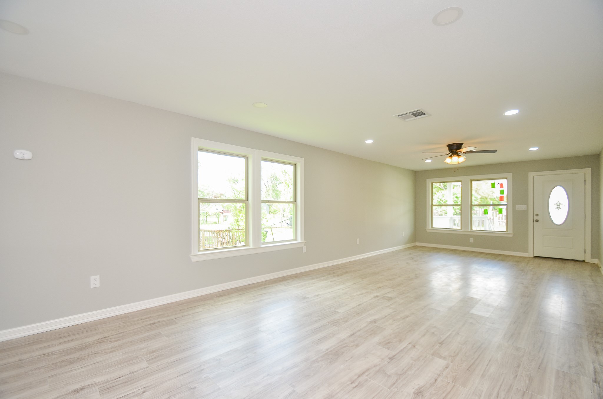 6114 Wedgefield Street Houston, TX 77028 - Photo 22 of 32 an empty room with wooden floor and windows