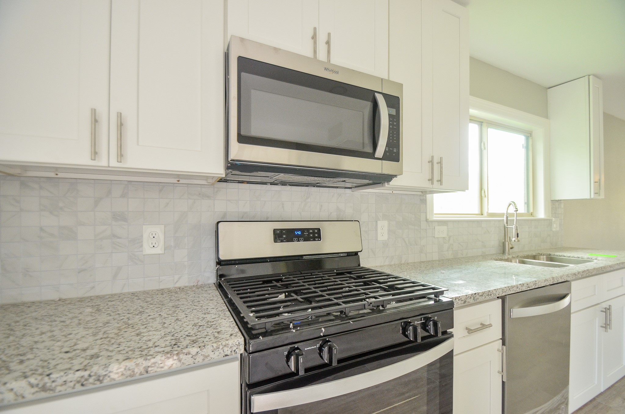 6114 Wedgefield Street Houston, TX 77028 - Photo 24 of 32 a kitchen with granite countertop a sink and a stove