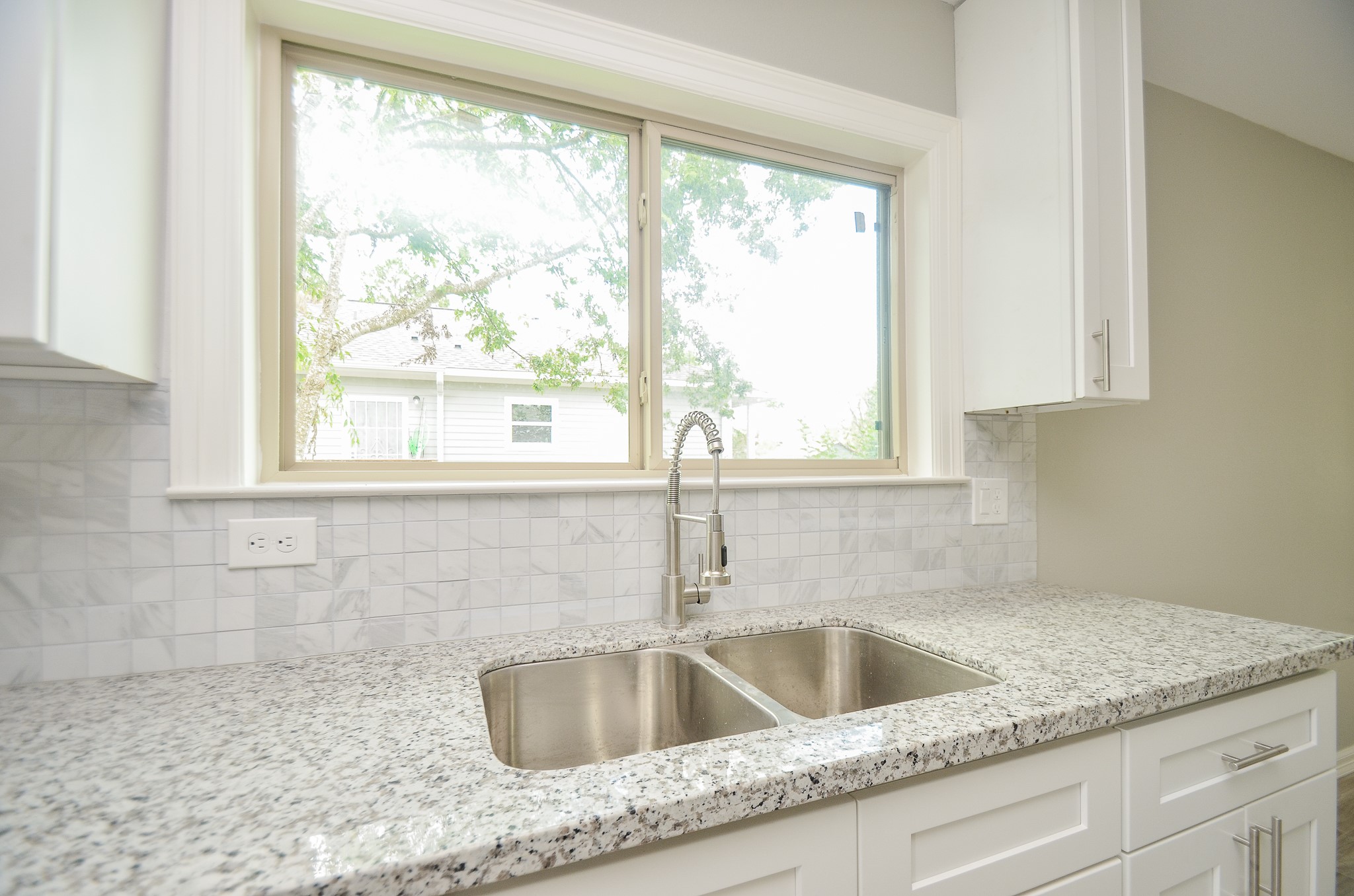 6114 Wedgefield Street Houston, TX 77028 - Photo 28 of 32 a kitchen sink with a granite countertop sink and a window