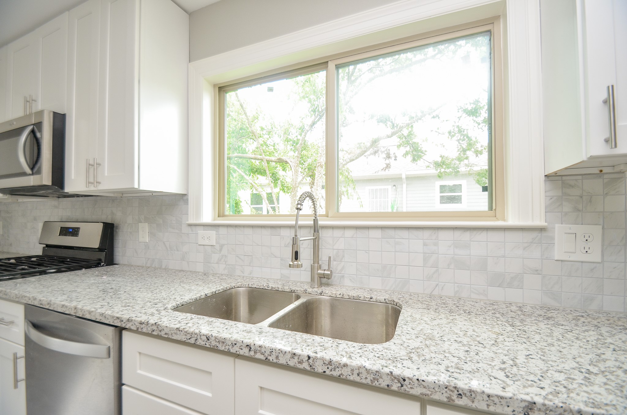6114 Wedgefield Street Houston, TX 77028 - Photo 29 of 32 a kitchen with granite countertop a sink and a window