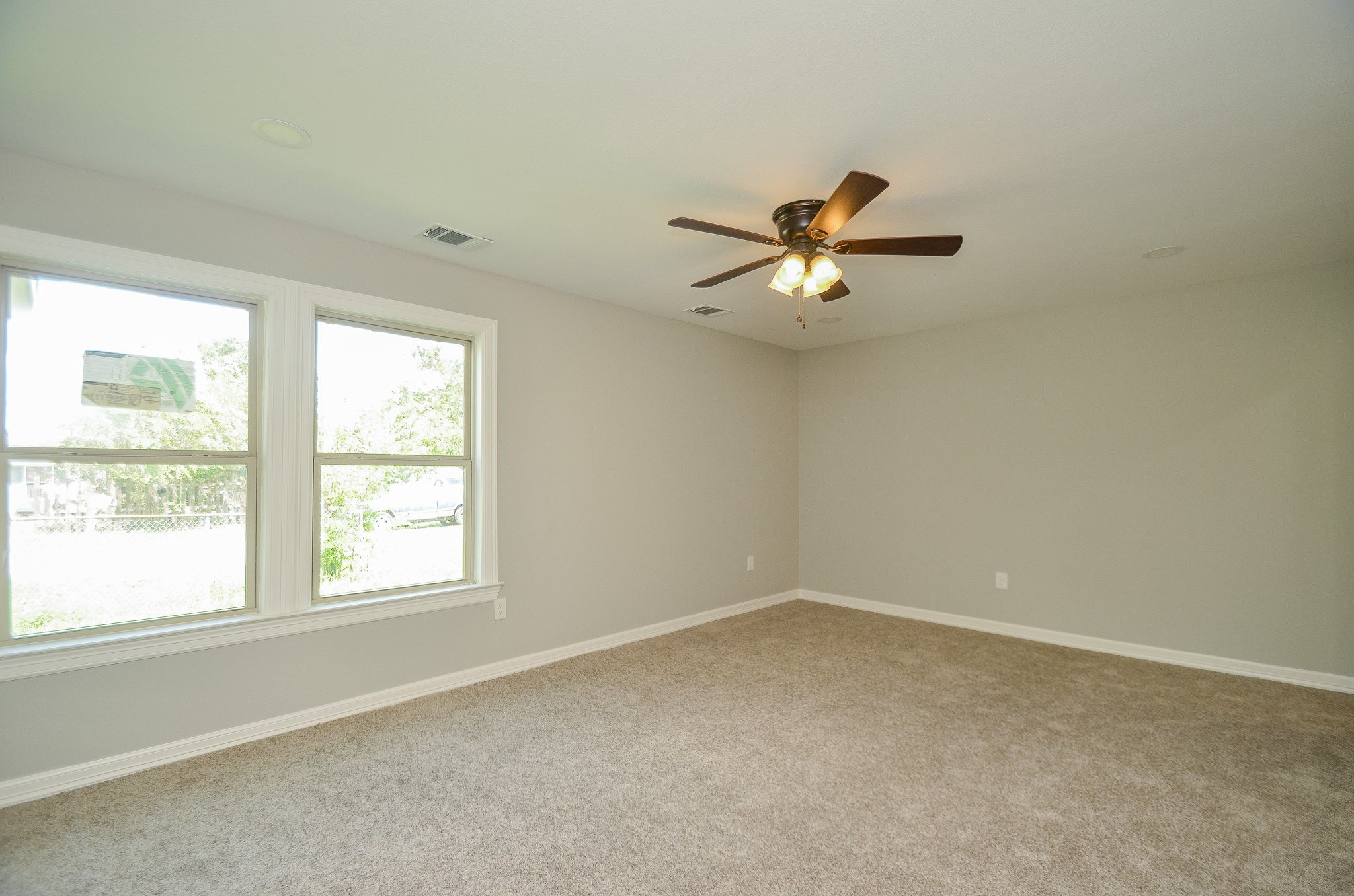 6114 Wedgefield Street Houston, TX 77028 - Photo 7 of 32 an empty room with a window and a ceiling fan