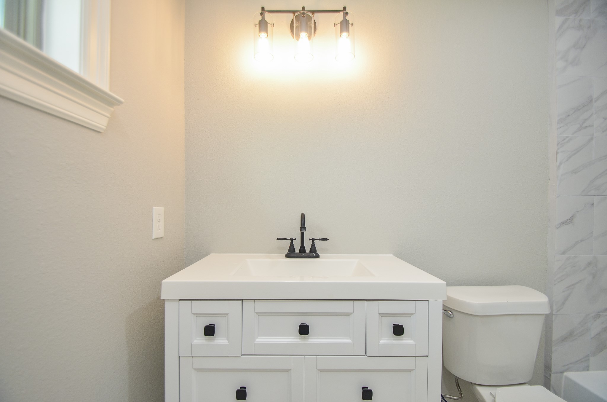 6114 Wedgefield Street Houston, TX 77028 - Photo 9 of 32 a bathroom with a sink a toilet and a mirror