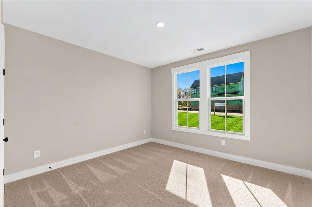 334 Summerall Drive Anderson, SC 29621 - Photo 23 of 28 This spacious room features ample natural light and plush carpeting, offering comfort and versatility.