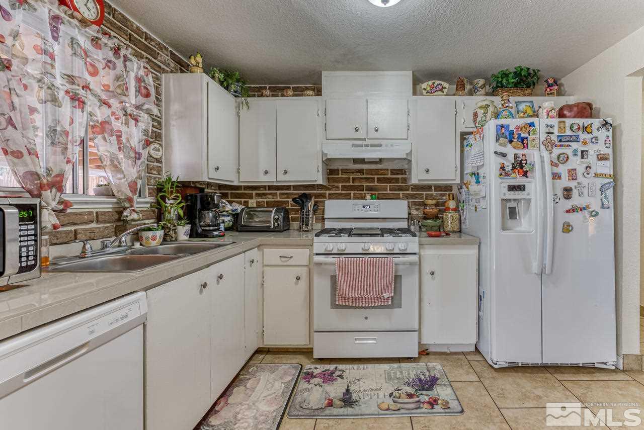 12085 Kernite Street Reno, NV 89506 - Photo 11 of 29 a kitchen with refrigerator and cabinets