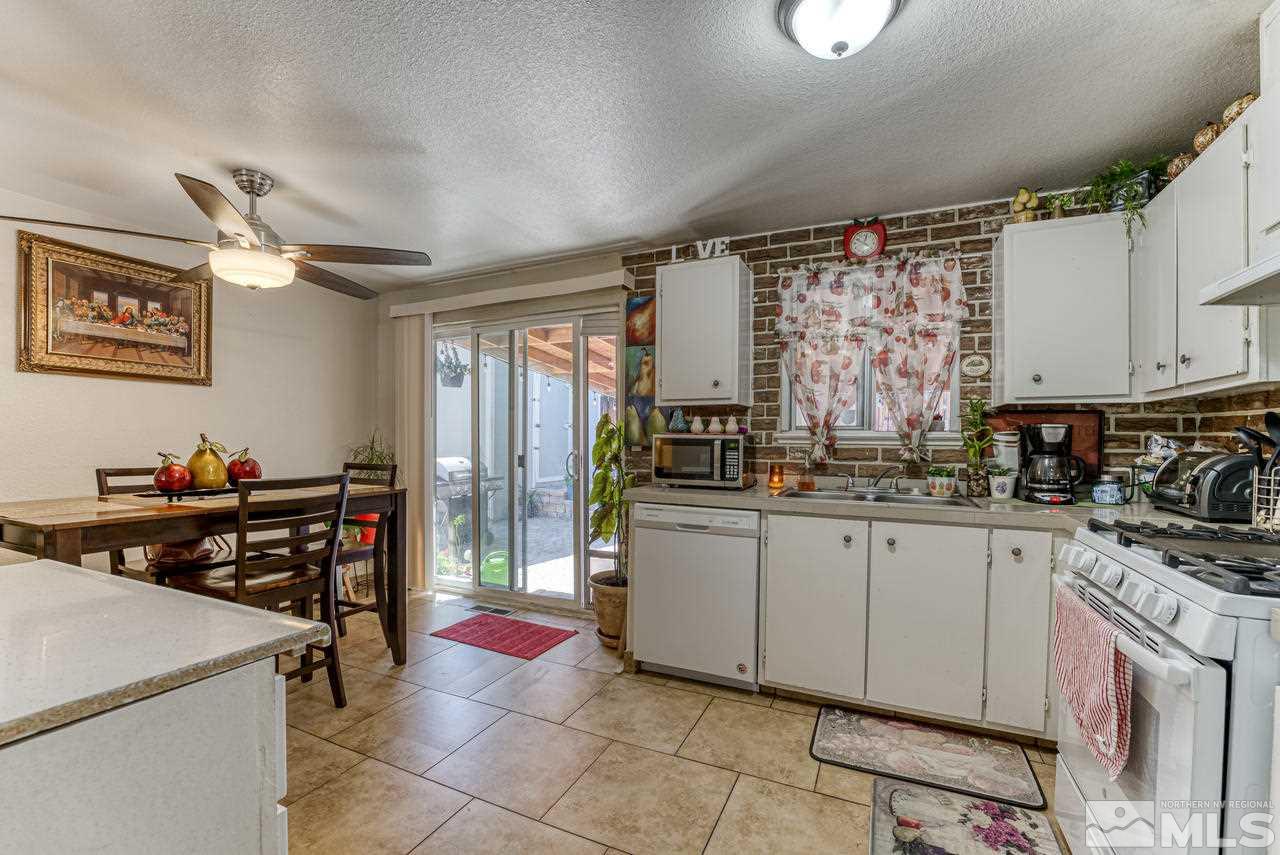 12085 Kernite Street Reno, NV 89506 - Photo 12 of 29 a kitchen with a stove a sink and a refrigerator