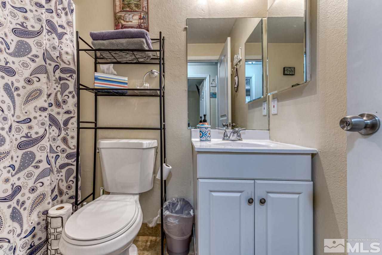 12085 Kernite Street Reno, NV 89506 - Photo 18 of 29 a bathroom with a toilet sink and mirror
