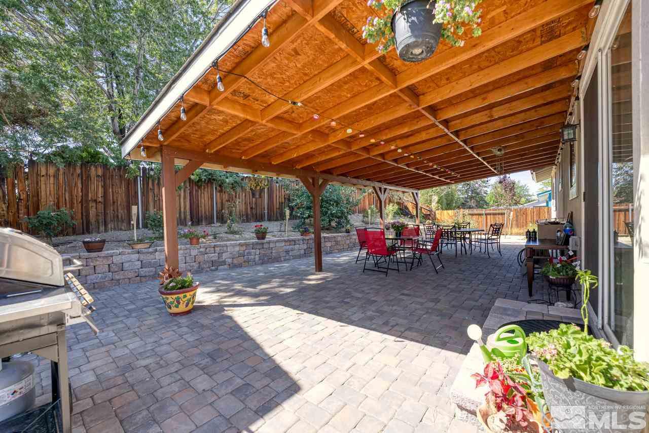 12085 Kernite Street Reno, NV 89506 - Photo 20 of 29 a view of a backyard with table and chairs potted plants
