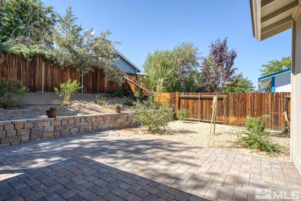 12085 Kernite Street Reno, NV 89506 - Photo 26 of 29 a backyard of a house with trees and outdoor space