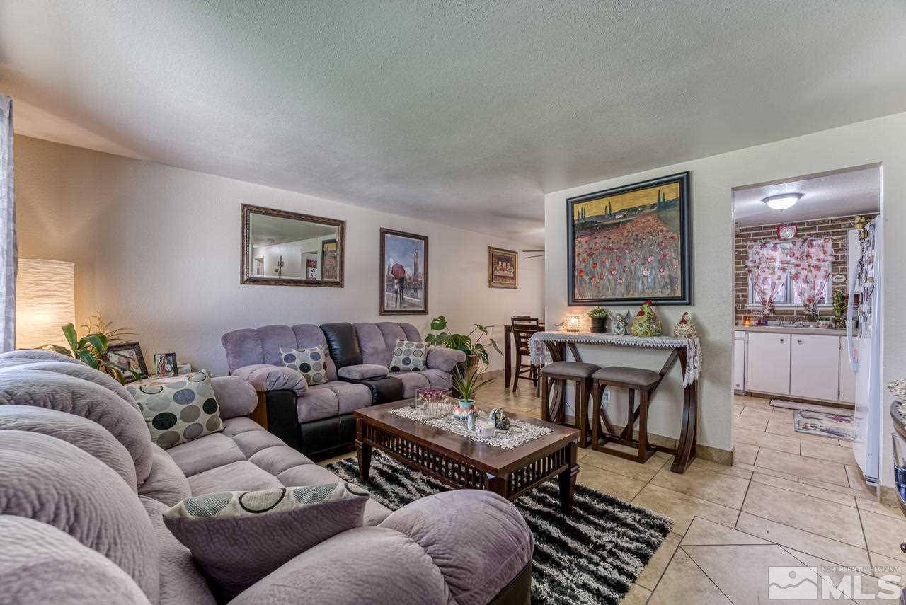 12085 Kernite Street Reno, NV 89506 - Photo 6 of 29 a living room with furniture potted plant and a window