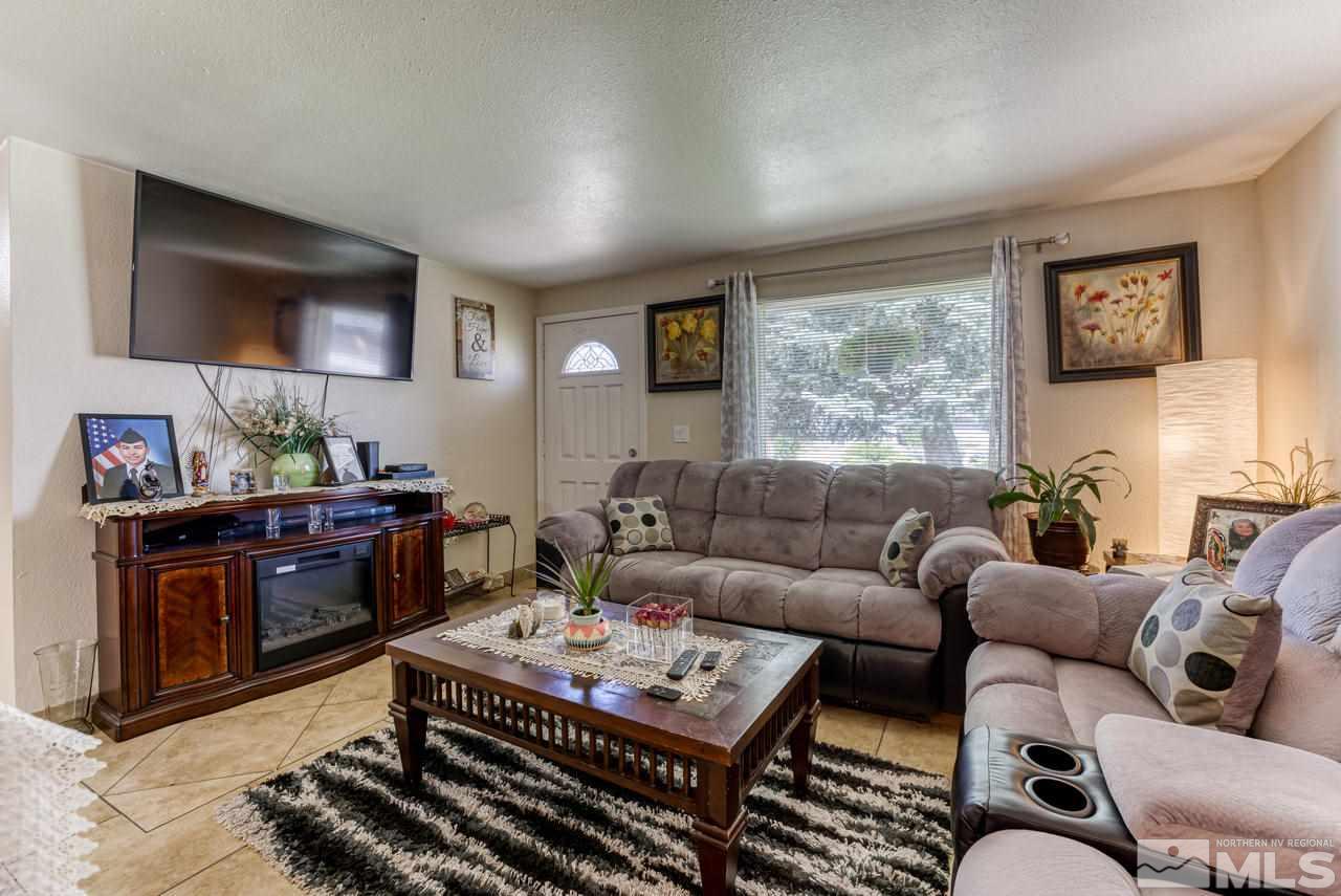 12085 Kernite Street Reno, NV 89506 - Photo 7 of 29 a living room with furniture a flat screen tv and kitchen view