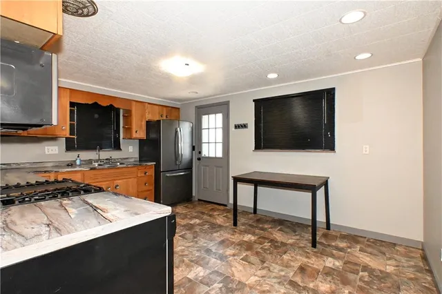 a living room with a flat screen tv and a refrigerator
