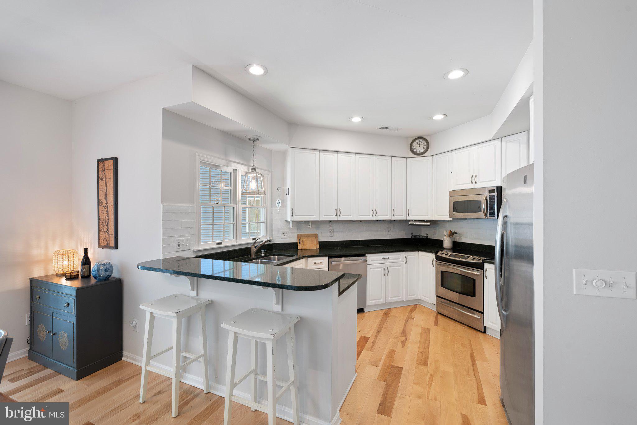 718 Foxtail Drive Bethany Beach, DE 19930 - Photo 15 of 39 a kitchen with a sink stove and refrigerator