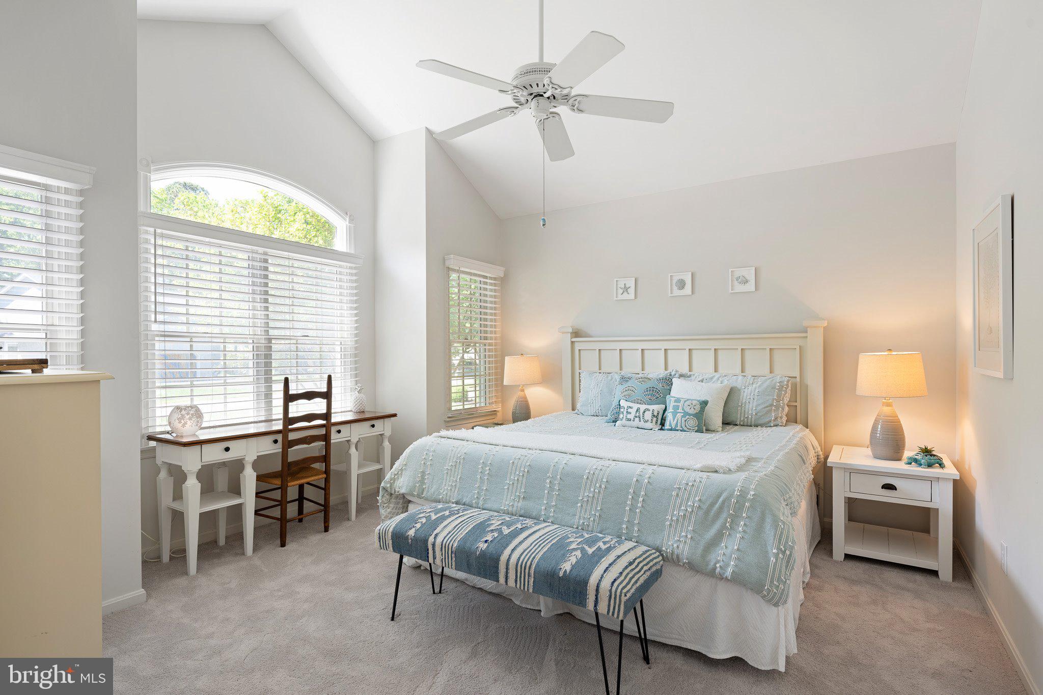718 Foxtail Drive Bethany Beach, DE 19930 - Photo 21 of 39 a bedroom with a bed and a chandelier