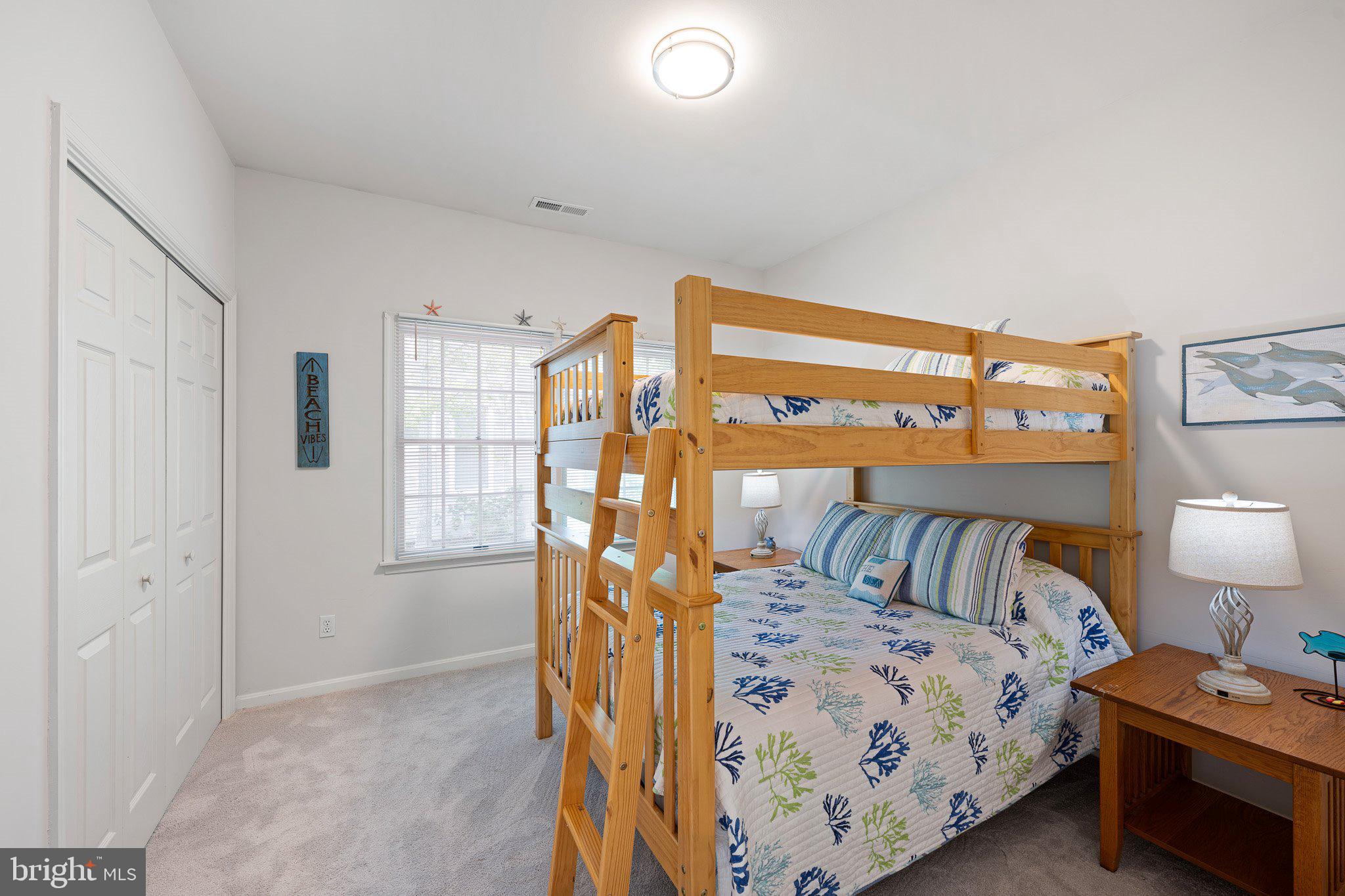 718 Foxtail Drive Bethany Beach, DE 19930 - Photo 24 of 39 a bedroom with a bed and a lamp