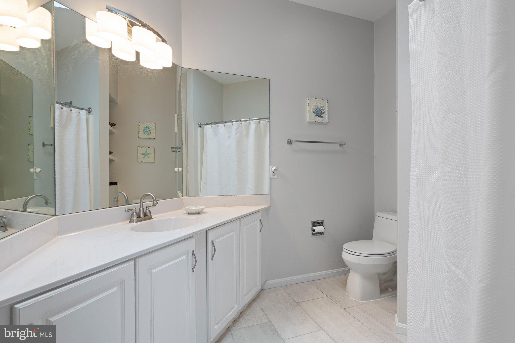 718 Foxtail Drive Bethany Beach, DE 19930 - Photo 25 of 39 a bathroom with a sink a toilet and shower