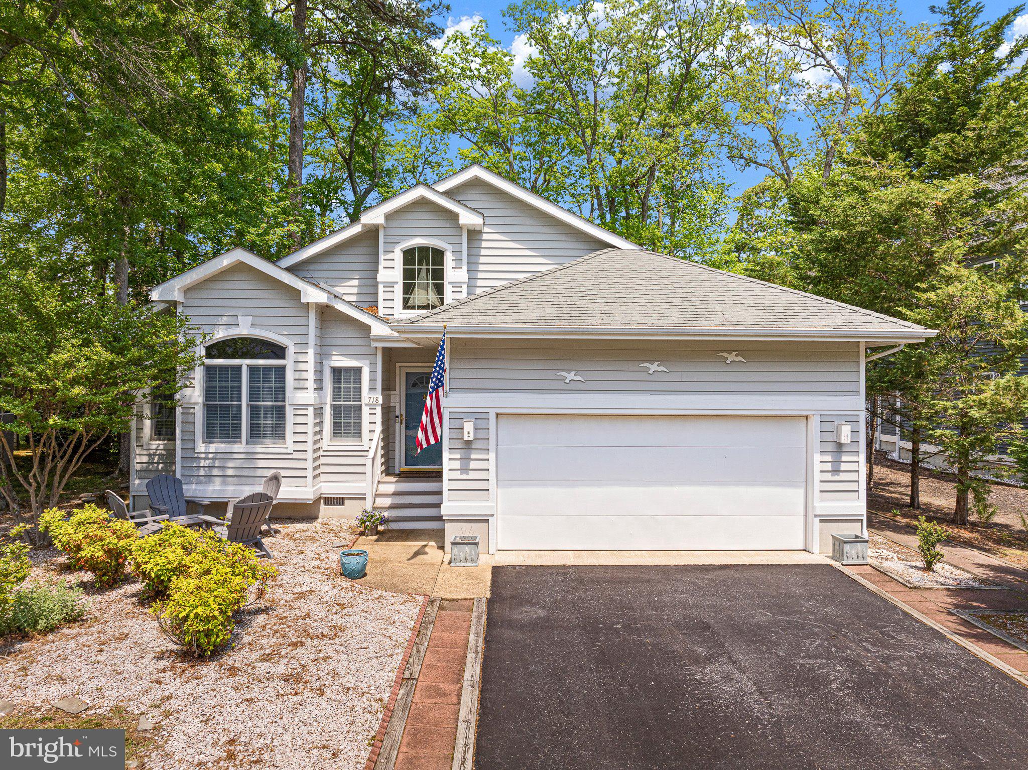 718 Foxtail Drive Bethany Beach, DE 19930 - Photo 3 of 39 a front view of a house with a yard and garage