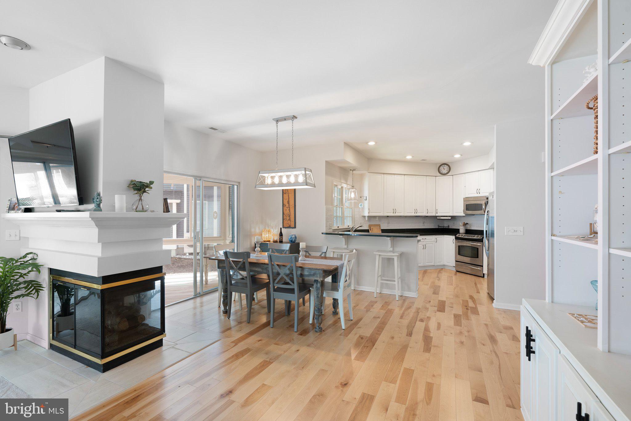 718 Foxtail Drive Bethany Beach, DE 19930 - Photo 9 of 39 a dining hall with stainless steel appliances kitchen island granite countertop a stove and a wooden floors