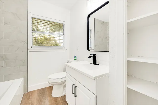a bathroom with a toilet sink and mirror