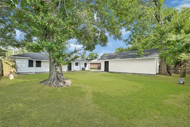 a front view of house with yard and trees