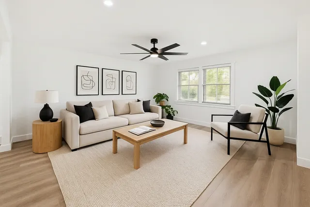 a living room with furniture a window and a chandelier