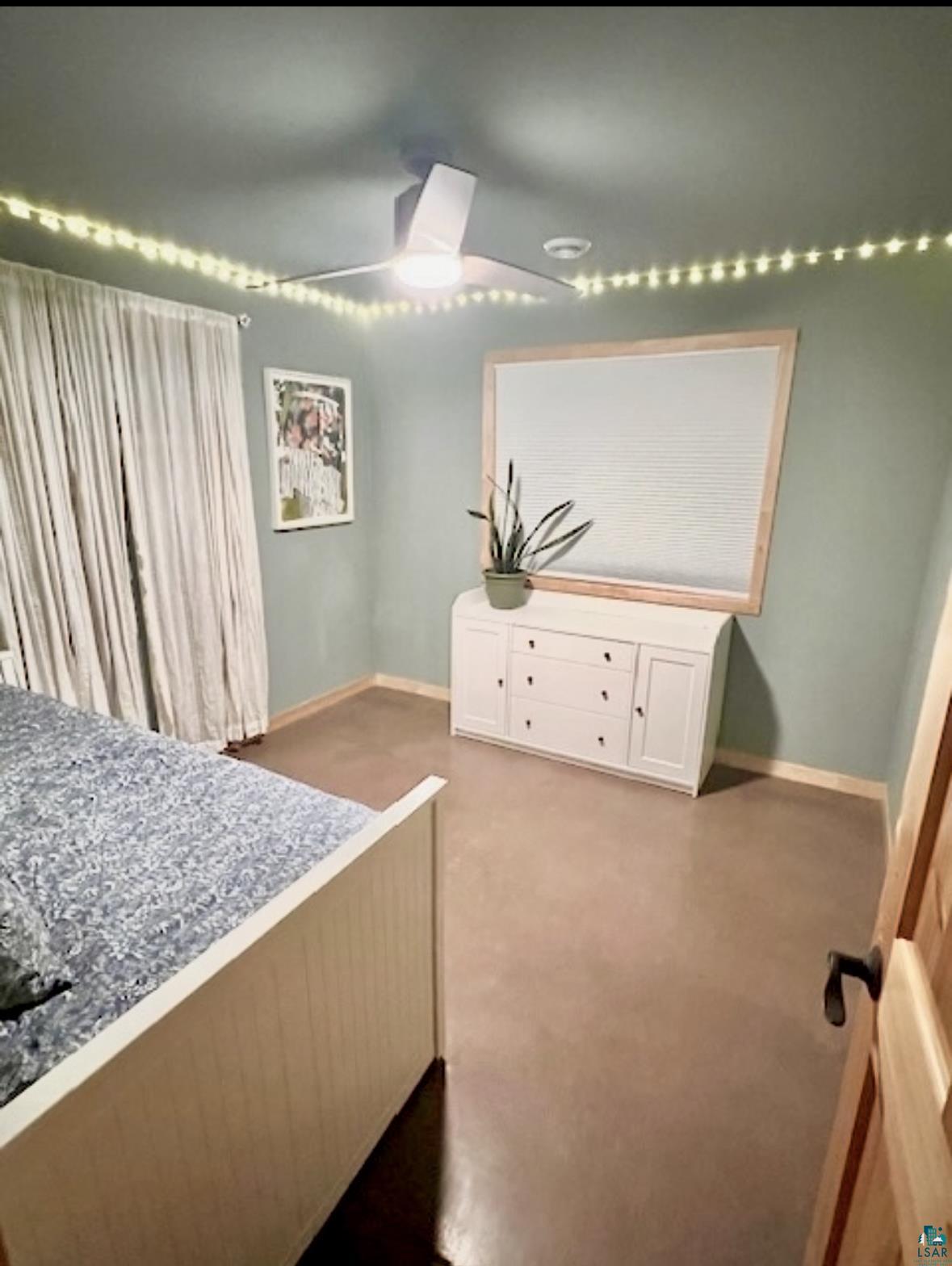 265 Mink Ranch Road Lutsen, MN 55612 - Photo 12 of 25 Bedroom featuring fairy lights that are dimmable