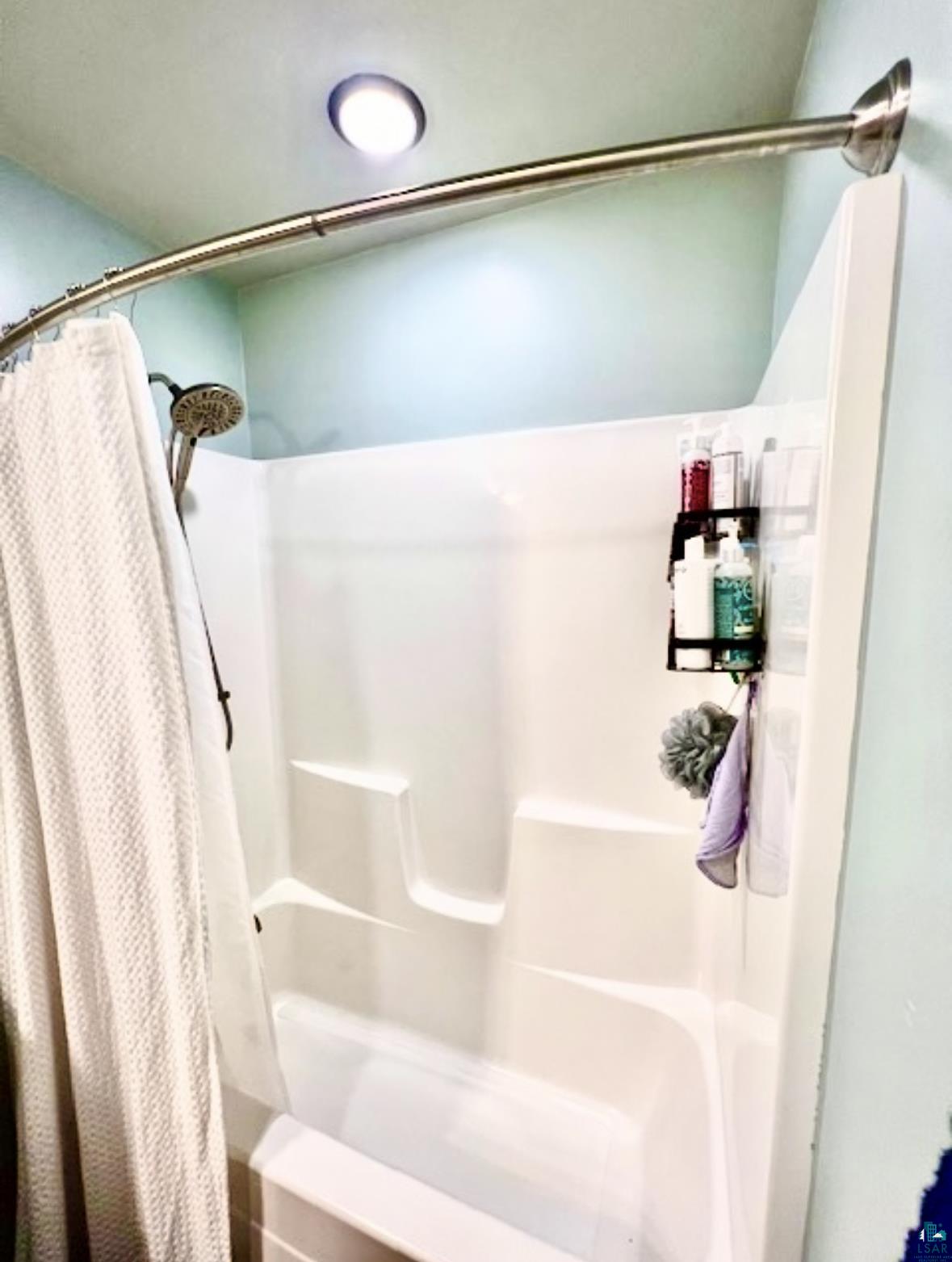 265 Mink Ranch Road Lutsen, MN 55612 - Photo 23 of 36 Bathroom featuring a shower with shower curtain