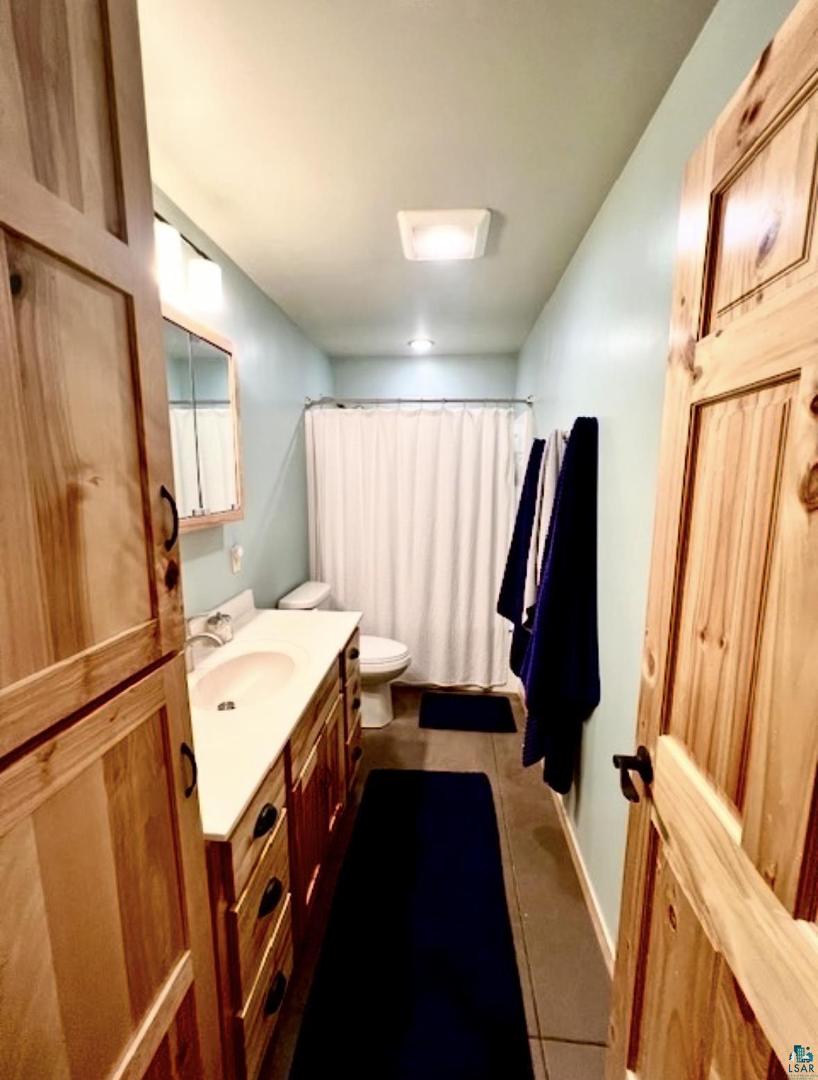 265 Mink Ranch Road Lutsen, MN 55612 - Photo 24 of 36 Full bath featuring vanity and dark tile patterned flooring