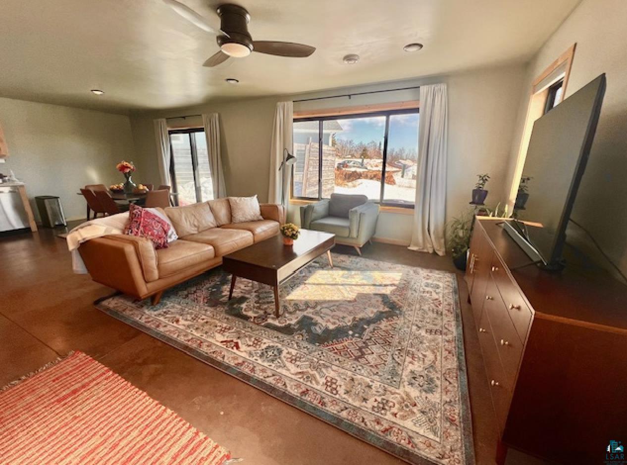 265 Mink Ranch Road Lutsen, MN 55612 - Photo 9 of 36 Living room featuring ceiling fan and healthy amount of natural light