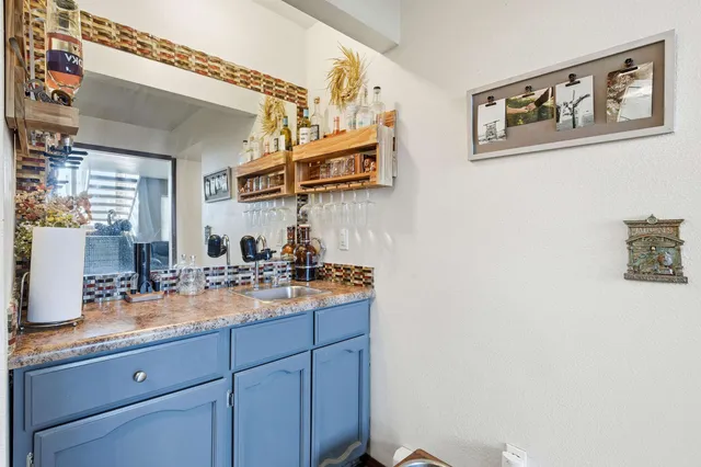 a kitchen with sink and cabinets
