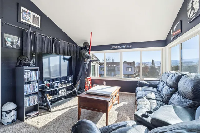 a living room with furniture fireplace and a large window
