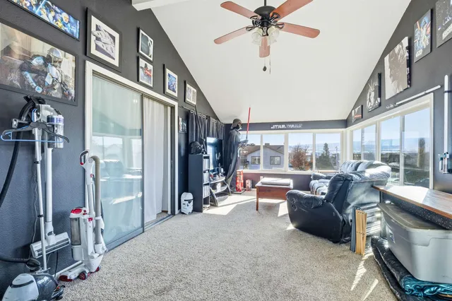 a living room with furniture and a floor to ceiling window