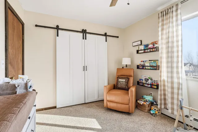 a bedroom with a flat screen television and a bed