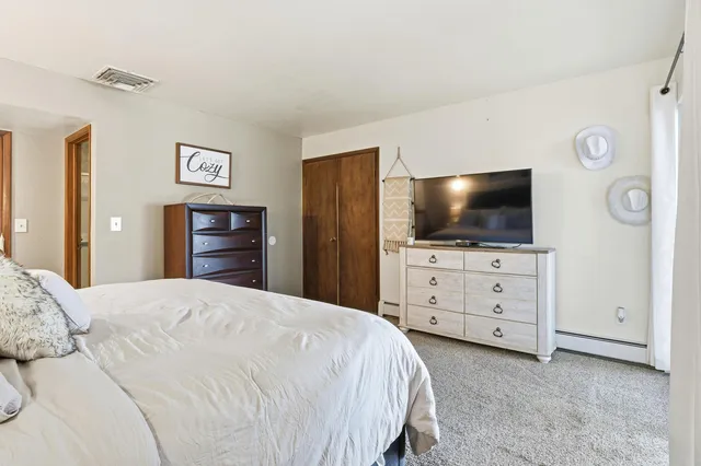 a bedroom with a bed and a dresser