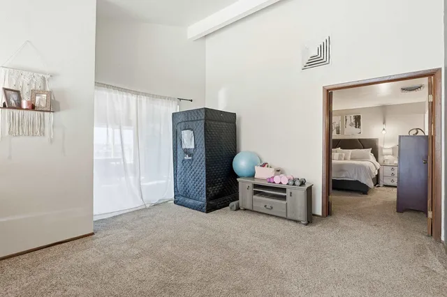 a bedroom with a large bed and a painting on the wall