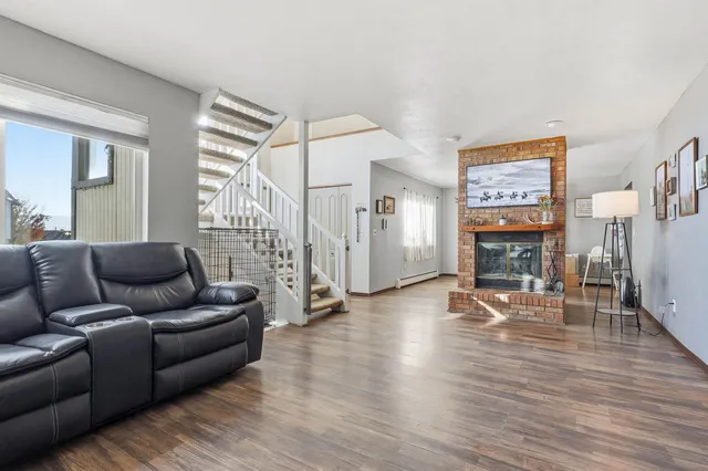 a living room with furniture and a wooden floor