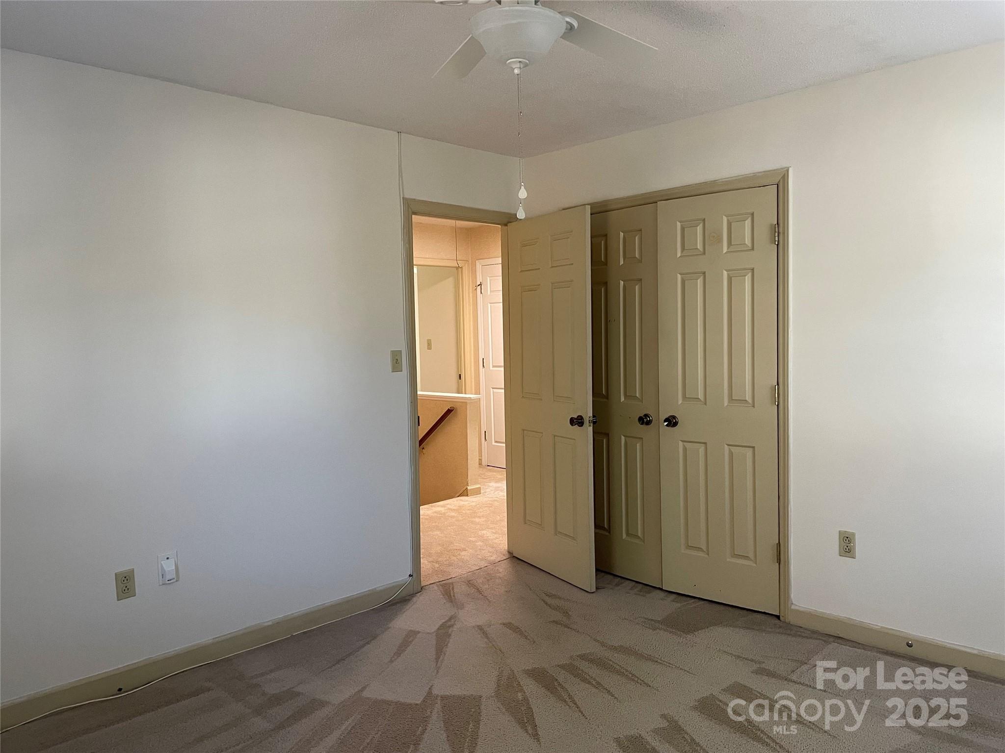 7327 Ricewell Road Charlotte, NC 28226 - Photo 14 of 22 a view of an empty room with wooden floor and a window