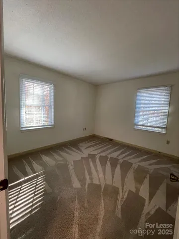 a bathroom with a granite countertop toilet sink and mirror