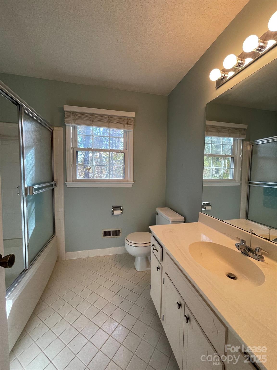 7327 Ricewell Road Charlotte, NC 28226 - Photo 18 of 22 a spacious bathroom with a granite countertop sink a toilet and shower