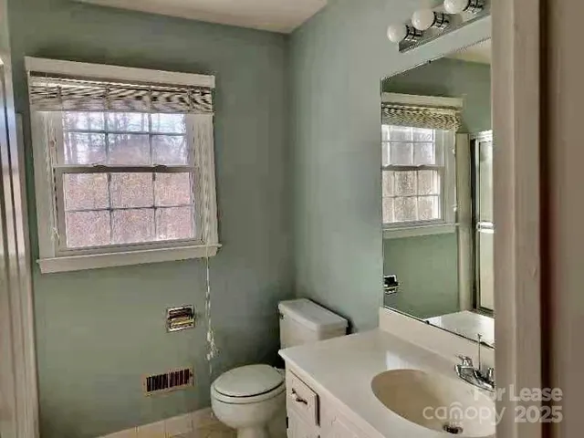 a view of a park with trees in the background