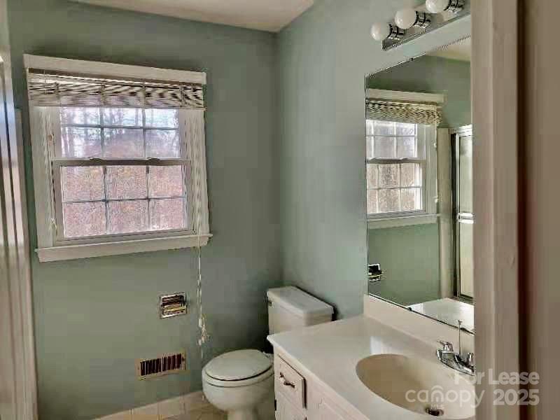 7327 Ricewell Road Charlotte, NC 28226 - Photo 19 of 22 a bathroom with a granite countertop toilet sink and mirror