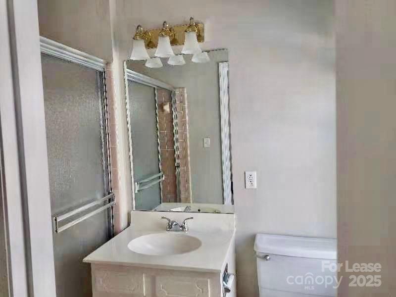 7327 Ricewell Road Charlotte, NC 28226 - Photo 20 of 22 a bathroom with a sink and a mirror