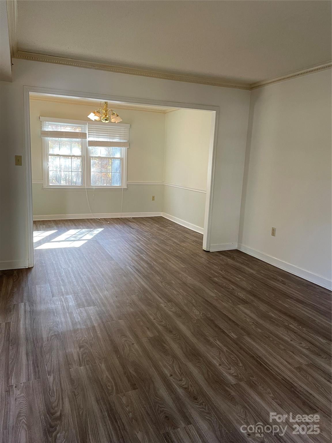 7327 Ricewell Road Charlotte, NC 28226 - Photo 5 of 22 a view of an empty room with wooden floor and a window