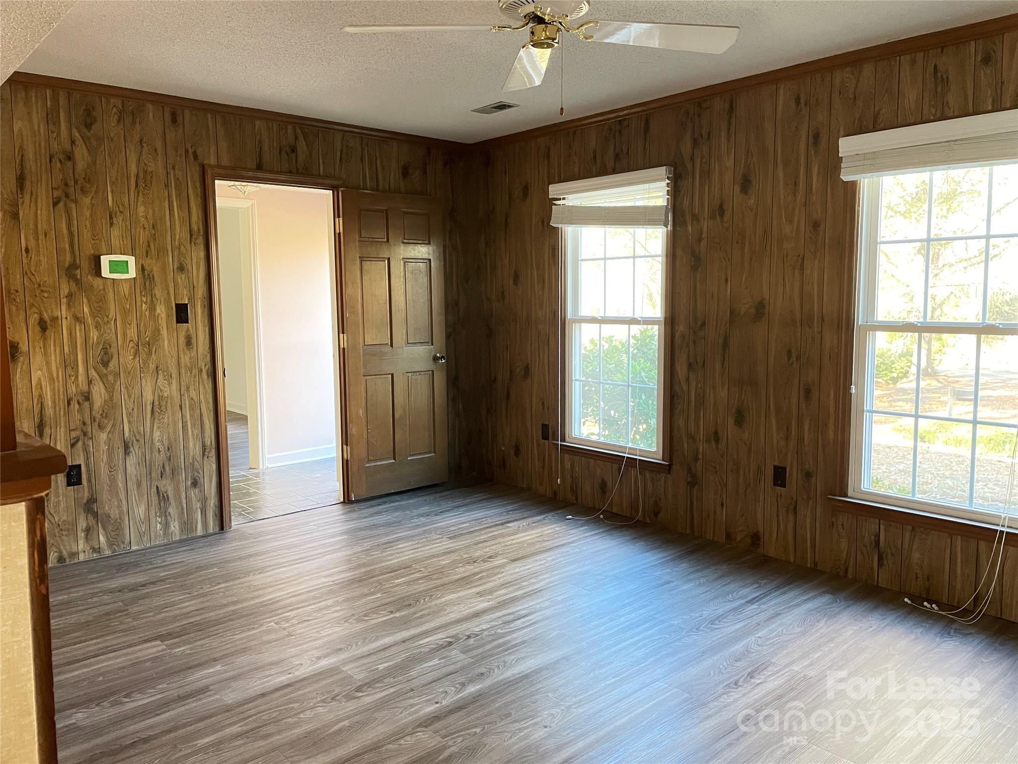 7327 Ricewell Road Charlotte, NC 28226 - Photo 8 of 22 an empty room with wooden floor and windows