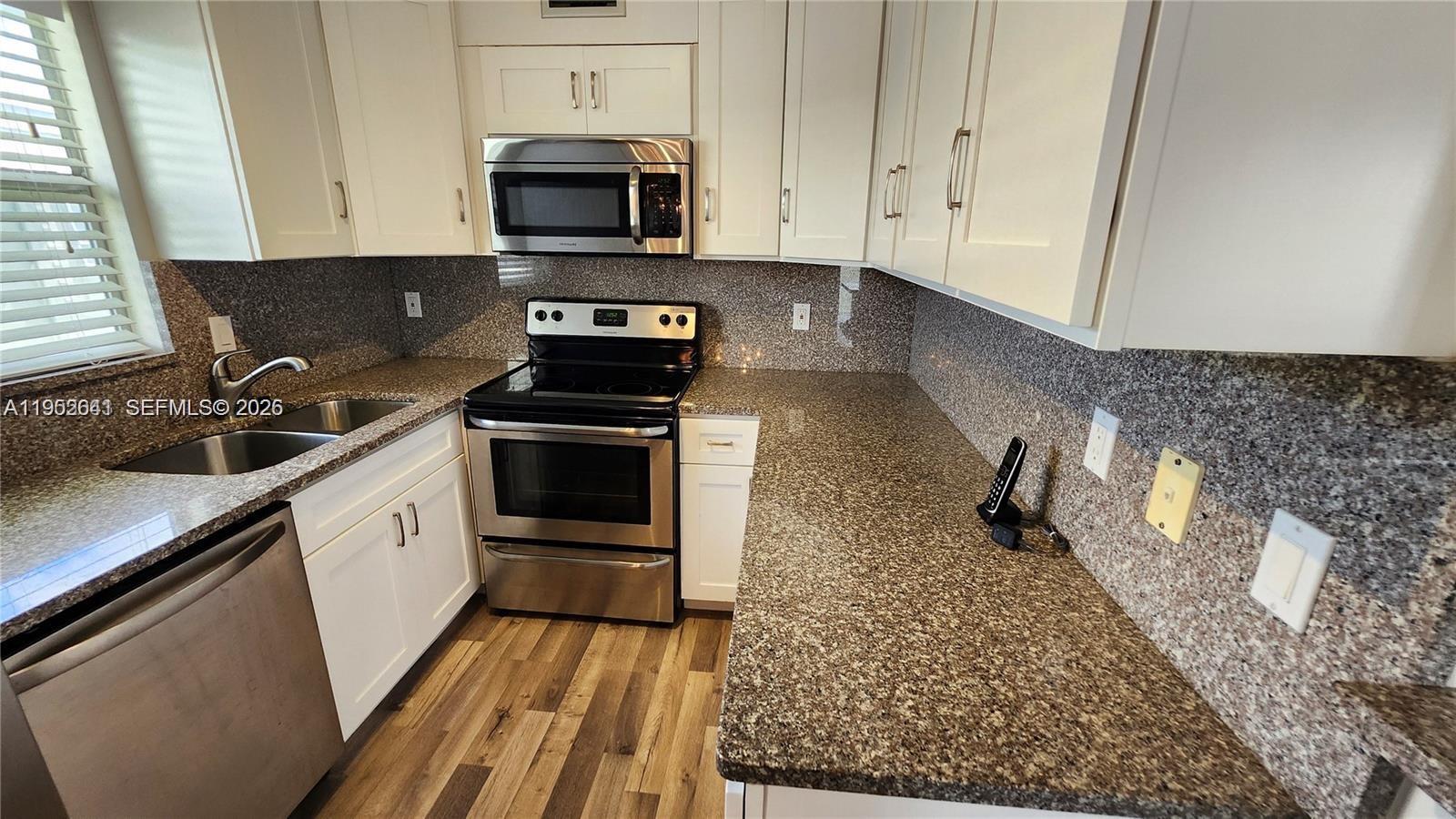 a kitchen with a sink stove and cabinets