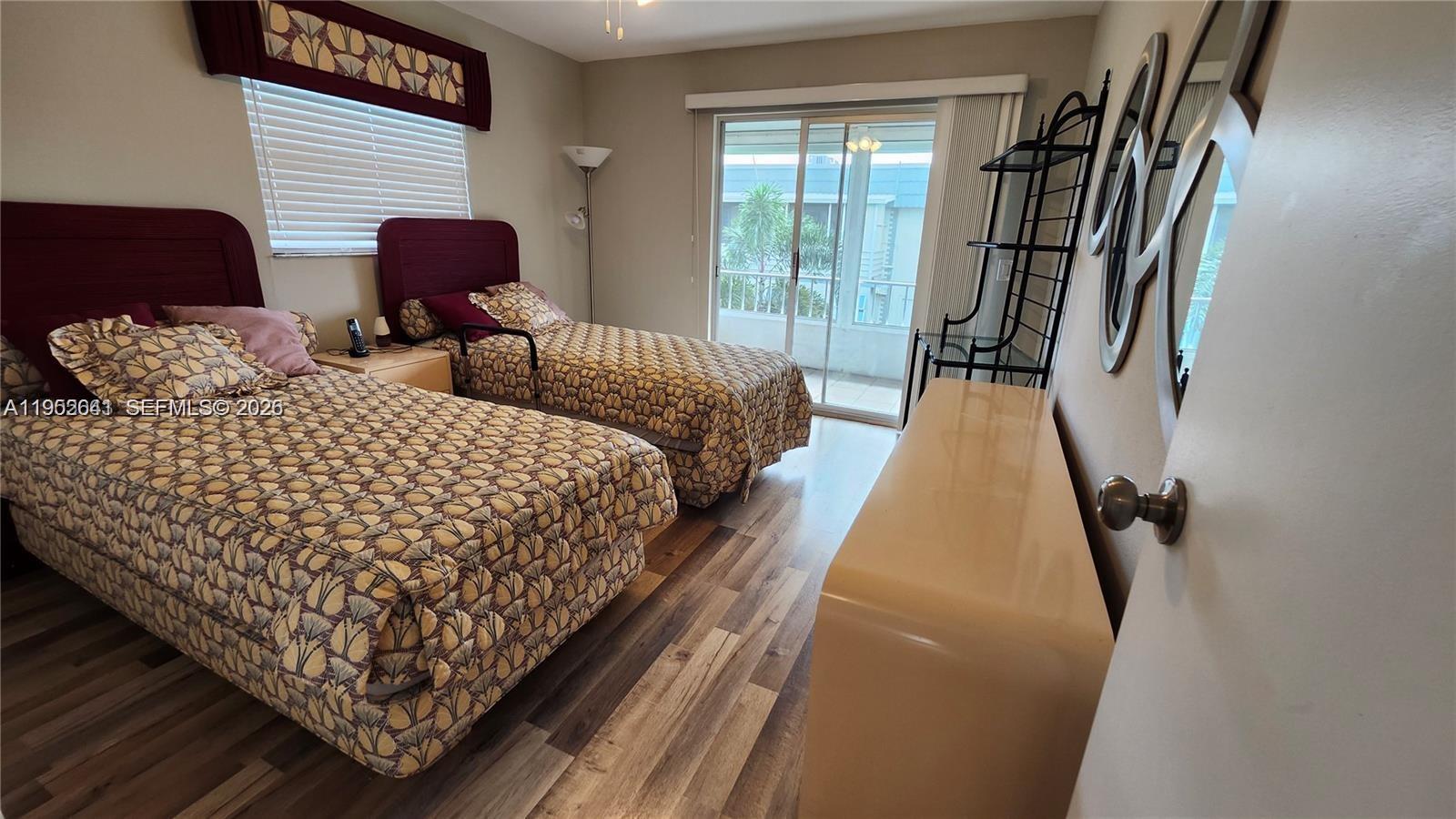 756 Flanders P Delray Beach, Unit 756 Delray Beach, FL 33484 - Photo 11 of 46 a bed sitting in a bedroom next to a window