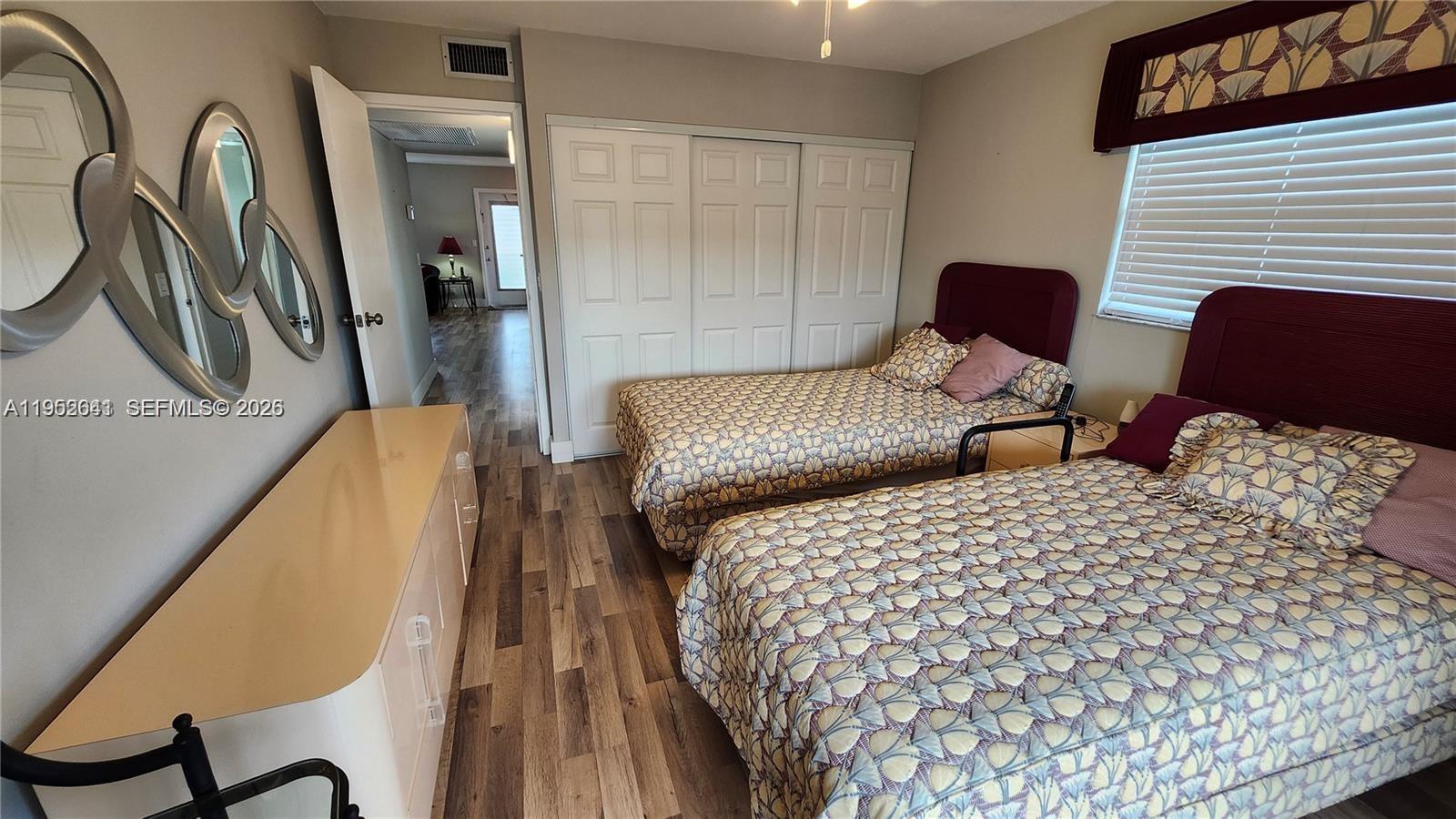 756 Flanders P Delray Beach, Unit 756 Delray Beach, FL 33484 - Photo 12 of 46 a bedroom with bed and wooden floor